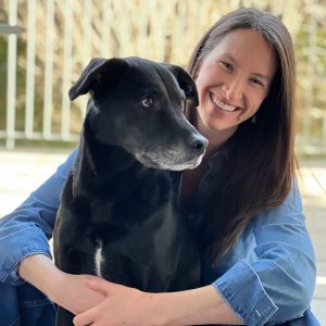 Author Bridget Farry with her black dog