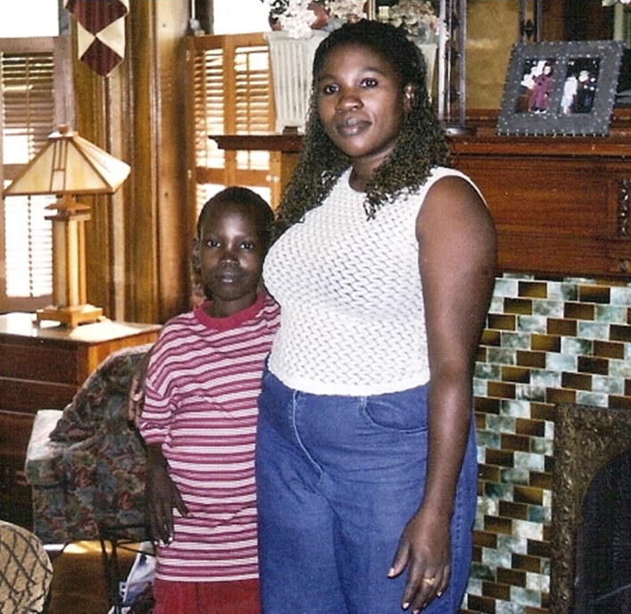 David and his mother, Doreen, stand together near a fireplace at the Ronald McDonald House