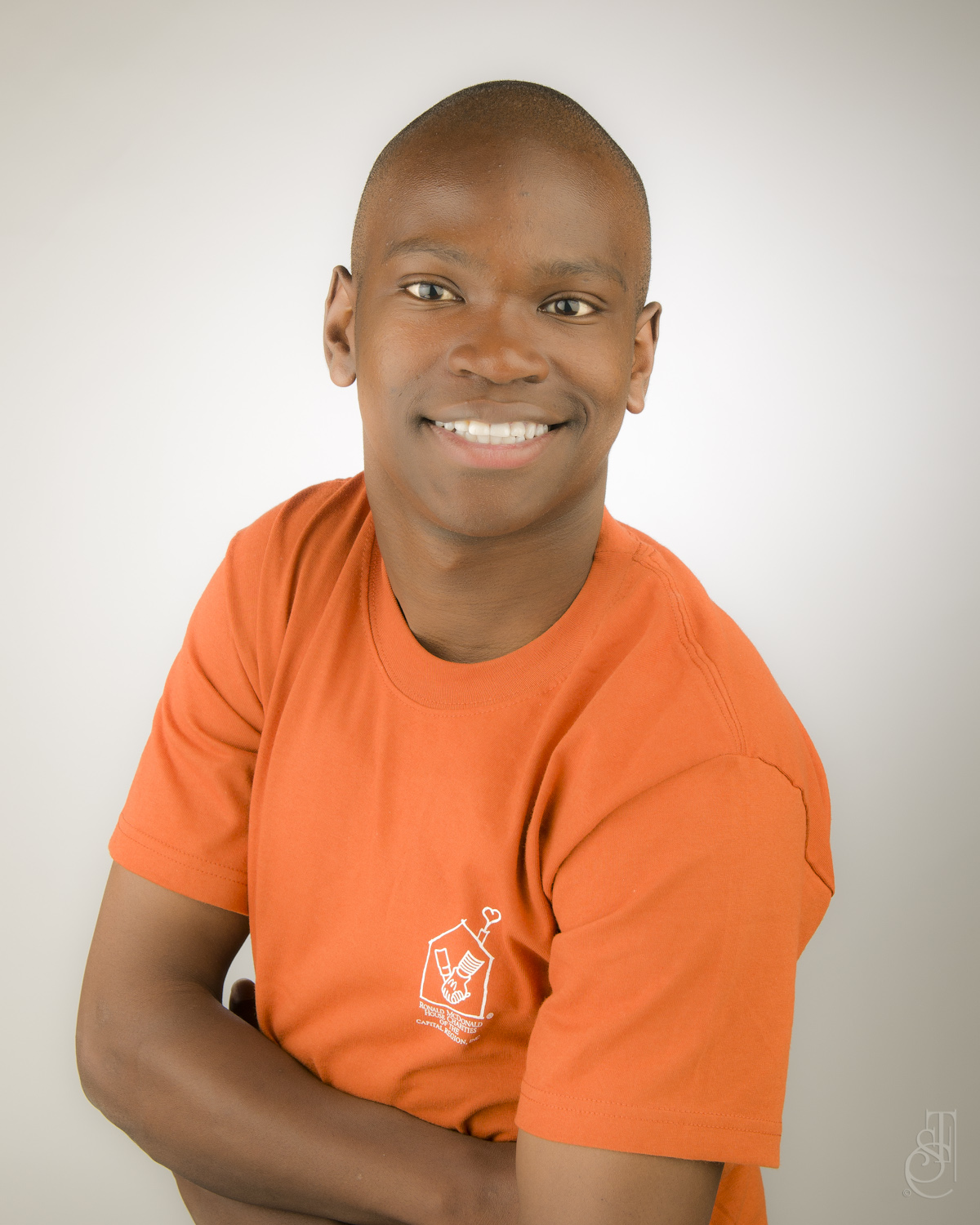 Teenage David poses for the camera in an orange RMHC t-shirt