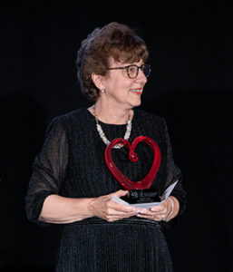 Debbie Ross receives a Distinguished Service Award (glass blown heart) at the 40 Years of Love Gala celebrating Ronald McDonald House Charities of the Capital Region.