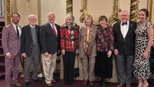 Standing, from left to right, RMHC Board President Dan Miller, Founders John Myers, Garry Finkell, Barbara Hoehn, Kathy Schoolcraft, Debbie Ross, and Dr. Bill Cromie, and CEO Kimmy Venter