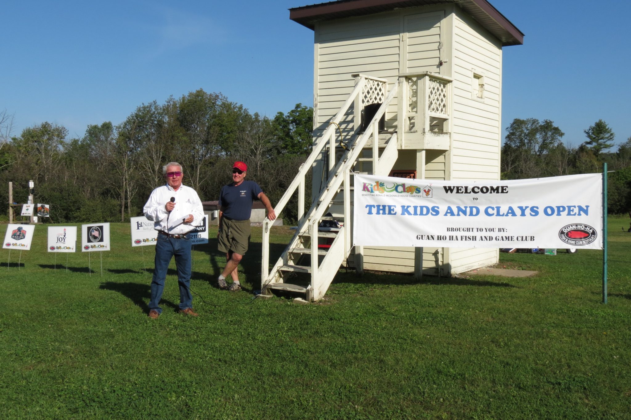 Kids & Clays Open event co-founder and Guan Ho Ha Club member Steve Borst watches as the Kids & Clays Foundation President, Bill Keyser, addresses the crowd before the event begins