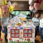 The Broadview community team prepares to push the RMHC Comfort Cart, decorated with lights and balloons, through the children's hospital at Albany Med.