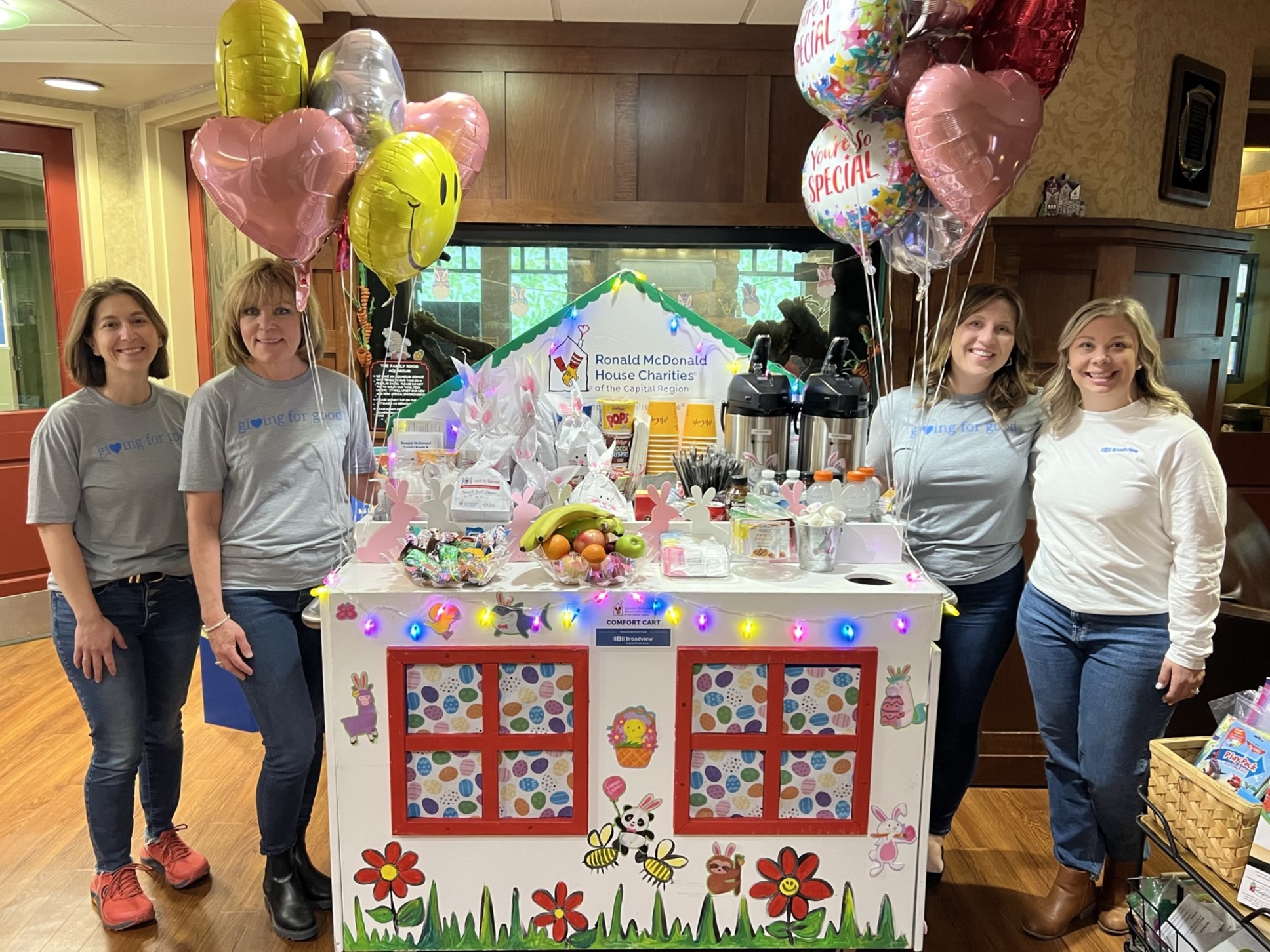 The Broadview community team prepares to push the RMHC Comfort Cart, decorated with lights and balloons, through the children's hospital at Albany Med.