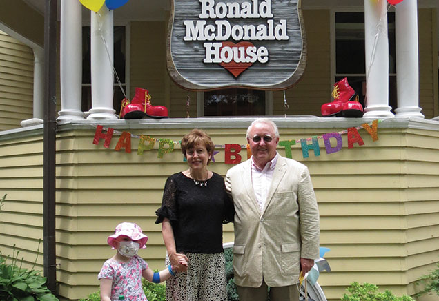 Debbie Ross and Dr. Bill Cromie celebrate the birthday of the Albany Ronald McDonald House with a child