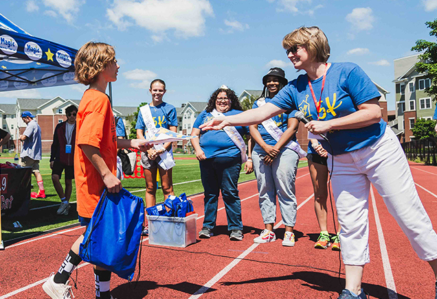 Student receiving a READ for RMHC award at the 2024 5K Fun Run & Birthday Bash